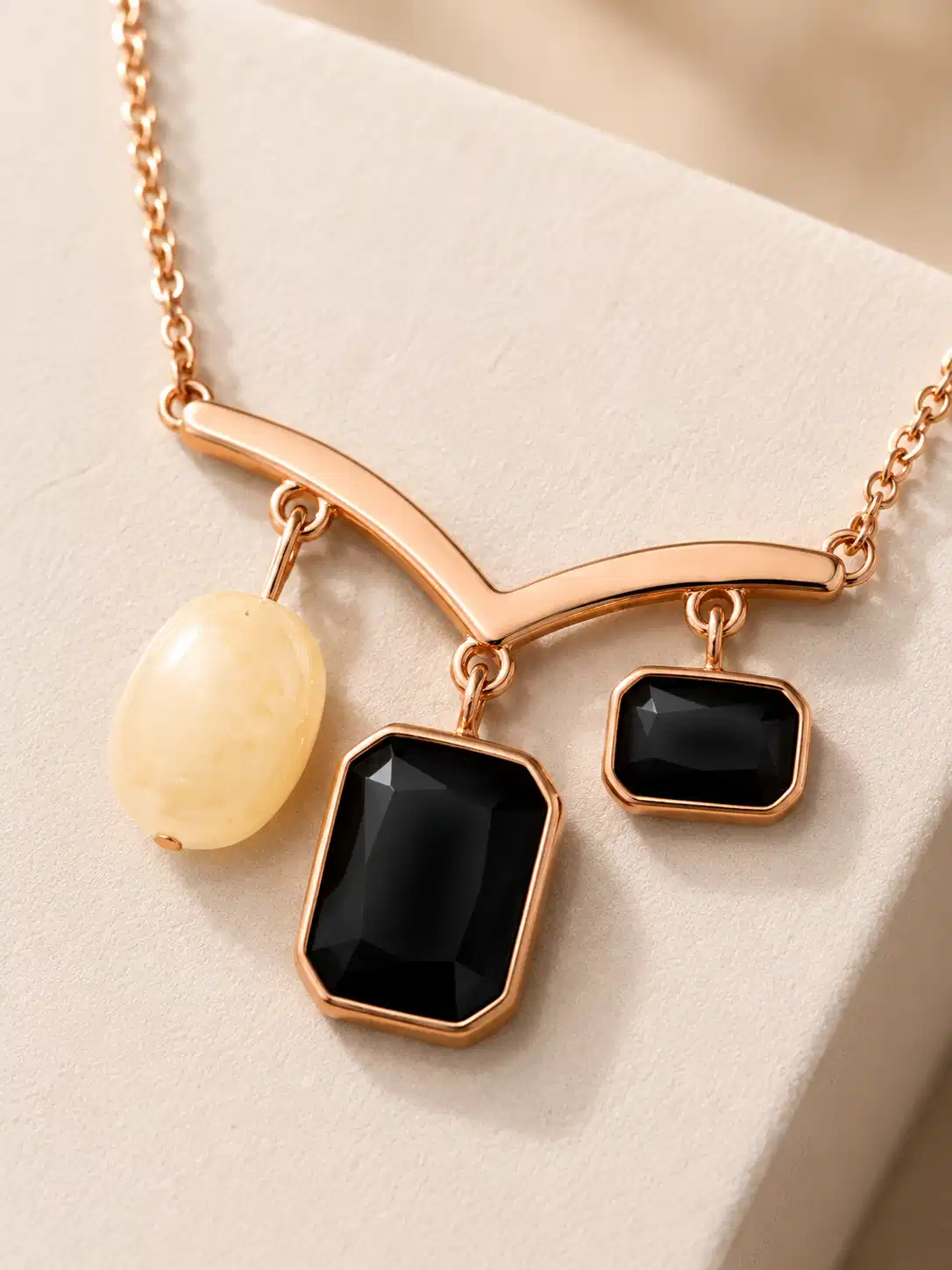 Close-up of black rectangular stones and pearl-inspired accent on the Nazar Grace pendant necklace