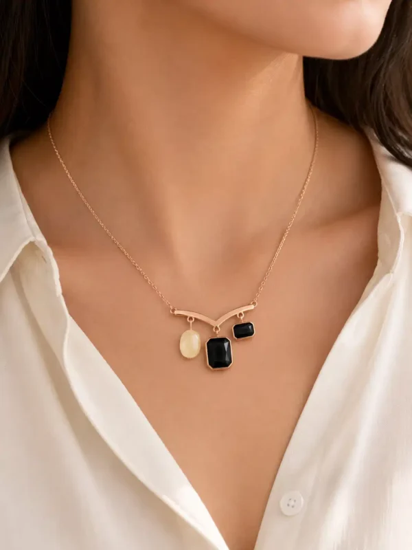 Close-up of black rectangular stones and pearl-inspired accent on the Nazar Grace pendant necklace