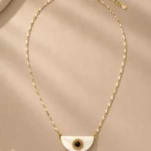 Nivara half-moon evil eye pendant necklace with a white, black and gold-tone design on a faceted chain