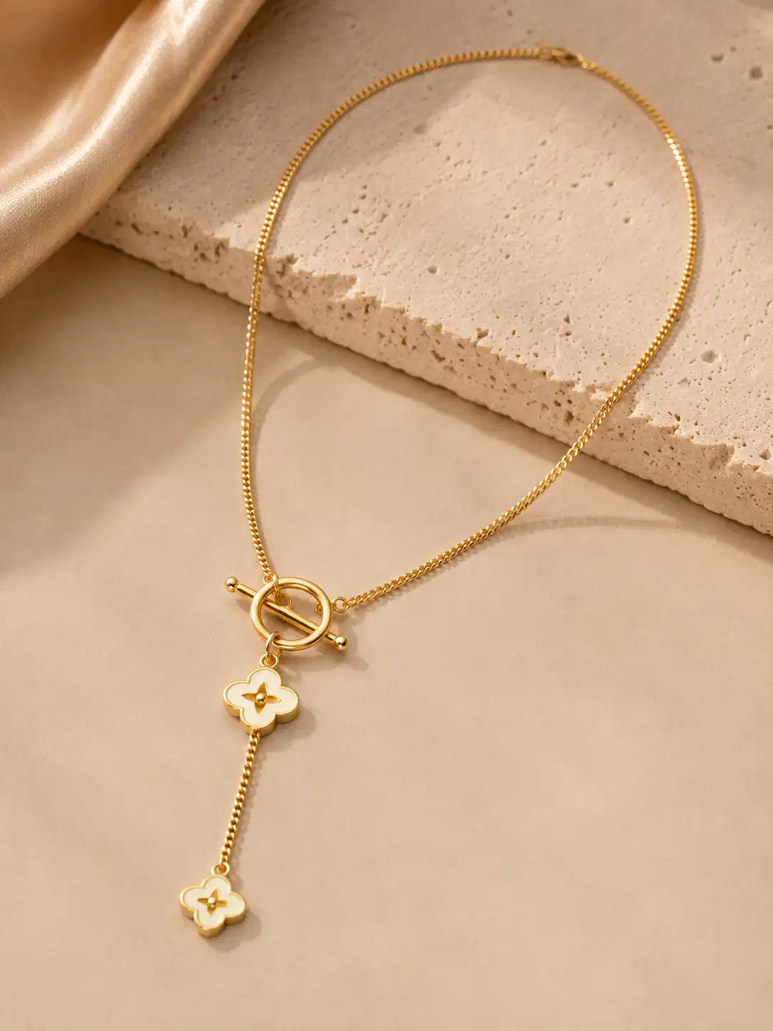 Full Fiora gold-tone floral Y necklace with ivory flower charms, fine link chain and graduated drop