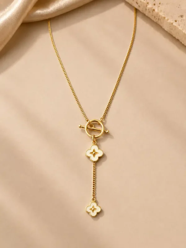 Front view of the Fiora ivory bloom Y necklace with a gold-tone chain and two graduated flower charms