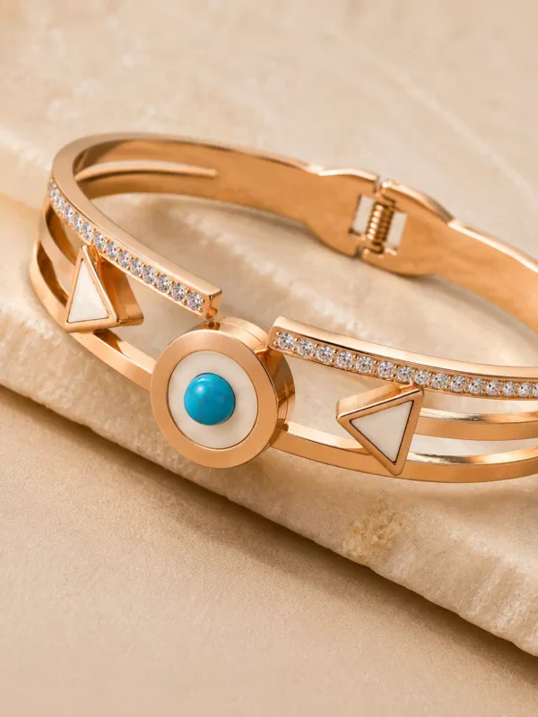 Close-up of the Veyra bangle’s turquoise-blue medallion, ivory triangles and clear stone-style row