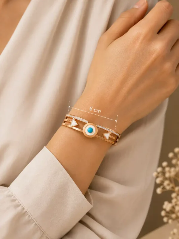 Veyra geometric hinged bangle worn on a woman’s wrist with a displayed 6 cm measurement