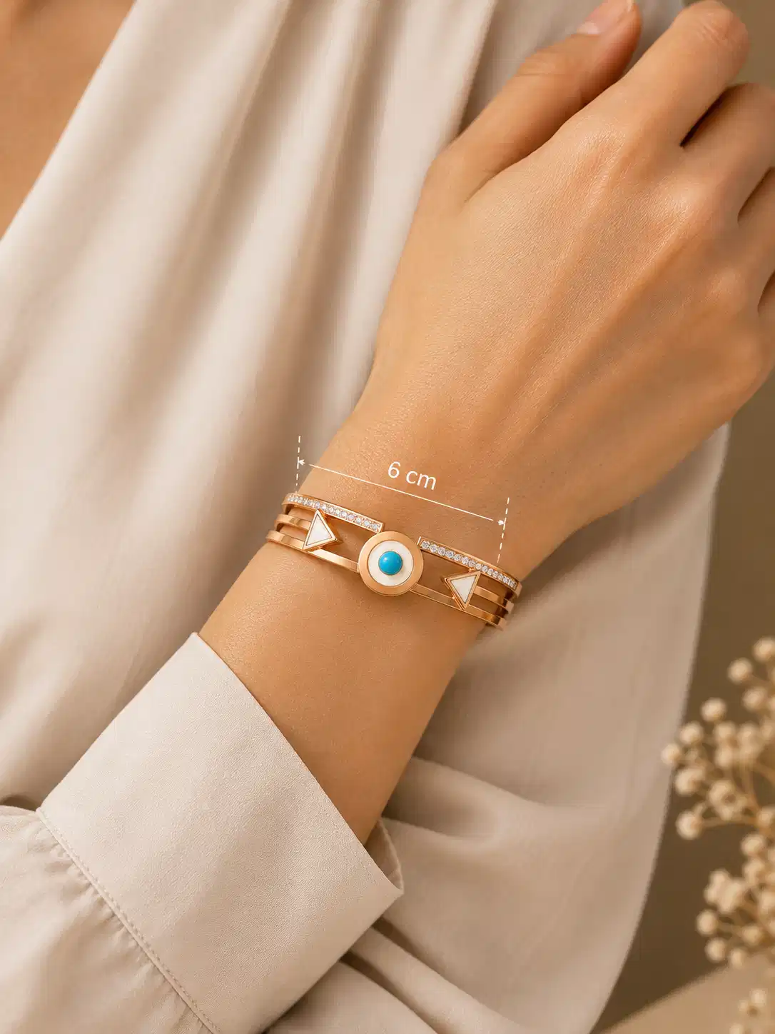 Veyra geometric hinged bangle worn on a woman’s wrist with a displayed 6 cm measurement