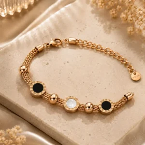 Full Mirelle rose-gold-tone multi-strand bracelet with three black and ivory discs, lobster clasp and extension chain