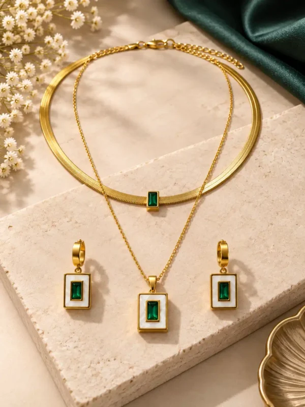 Gold-tone double-layer necklace and matching earrings with emerald-green rectangular stones and ivory frames