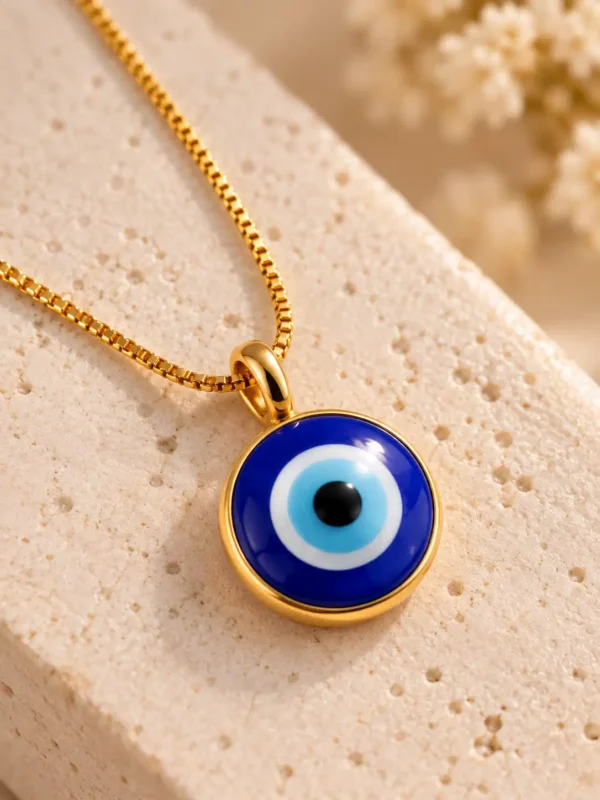 Close-up of round blue evil eye pendant with cobalt outer ring, white and light-blue layers and black centre