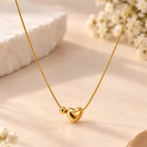 Quiet Love gold-tone heart necklace for women with polished 3D heart and small bead detail