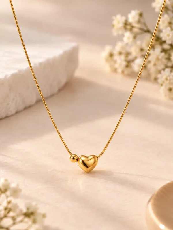 Quiet Love gold-tone heart necklace for women with polished 3D heart and small bead detail