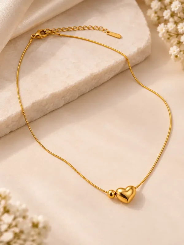 Adjustable gold-tone heart necklace with 3D heart charm, bead detail, lobster clasp and extension chain