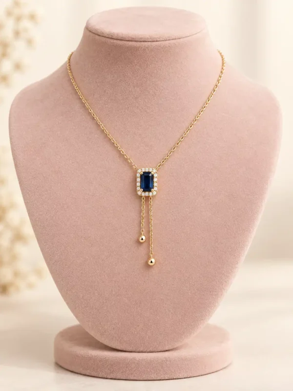 Blue Hour Y-Drop Necklace with deep blue rectangular stone, crystal halo and gold-tone double drop design by Orika Jewels