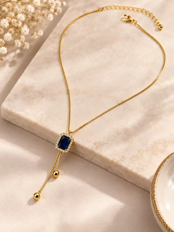 Adjustable Blue Hour gold-tone Y-drop necklace with blue crystal centre, lobster clasp and extension chain