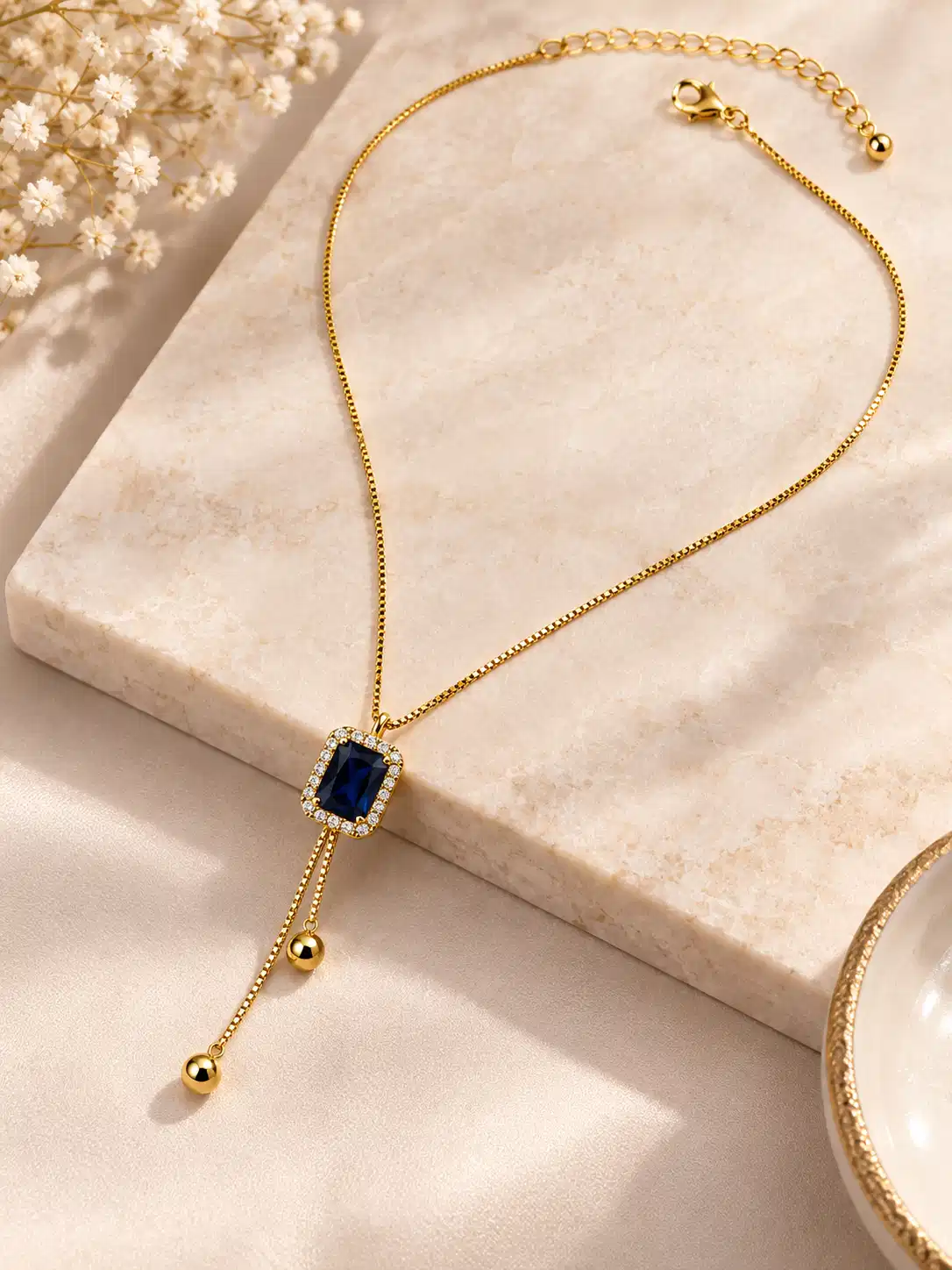 Adjustable Blue Hour gold-tone Y-drop necklace with blue crystal centre, lobster clasp and extension chain