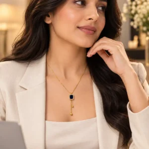 Woman in white blazer wearing Blue Hour blue Y-drop necklace as elegant office wear jewellery for women