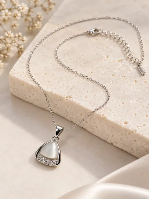 Adjustable silver-tone pendant necklace with white triangle centre, crystal accents and extension chain