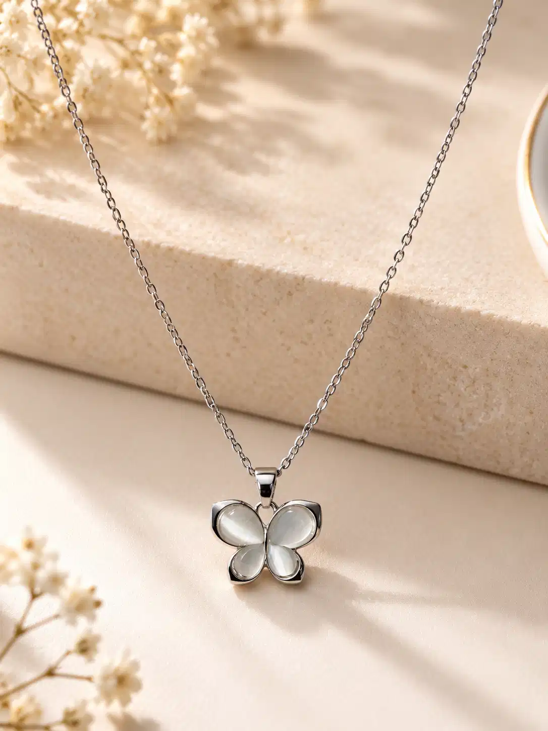 Luna Glow silver butterfly pendant necklace with luminous white wings and polished silver-tone chain for women