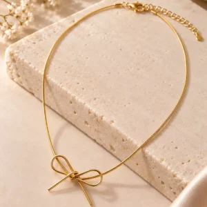 Poise Bow Gold Necklace for women with sculptural ribbon motif and sleek adjustable gold-tone chain.