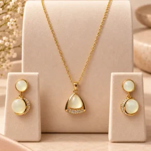 Gold-tone ivory pendant and matching drop earring set for women with subtle crystal detailing