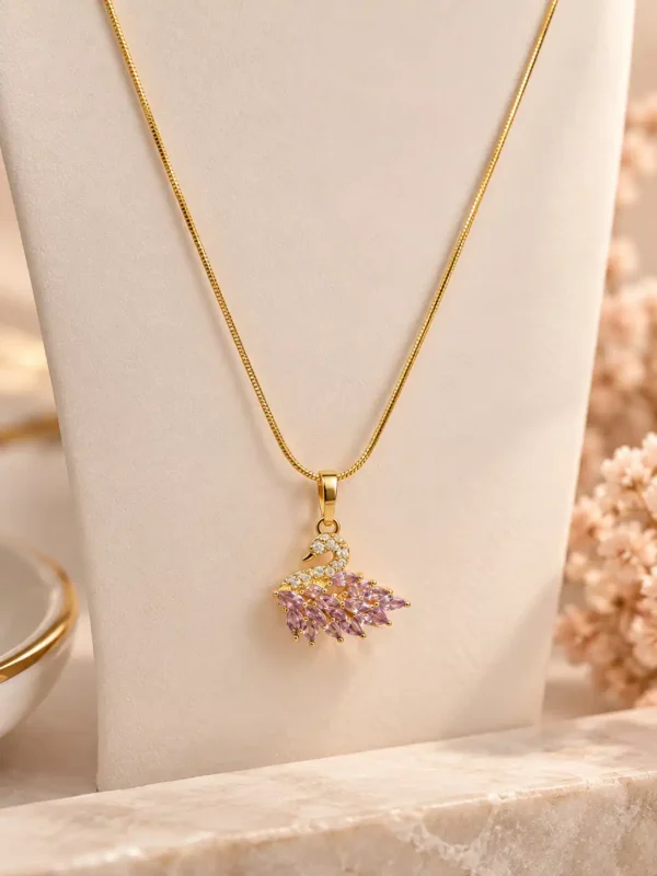 Gold-tone swan pendant necklace with blush pink marquise stones and clear accents by Orika Jewels
