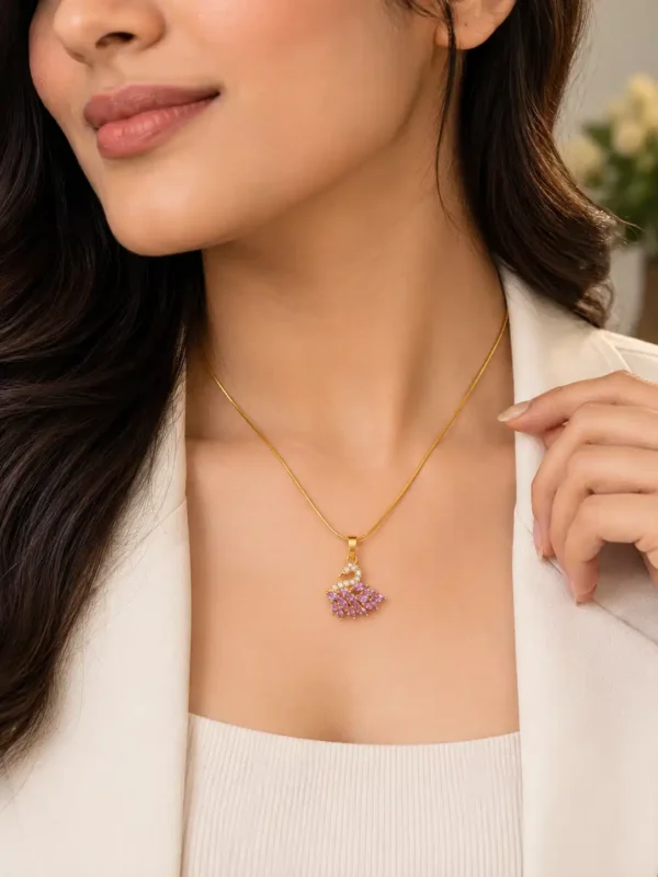 Woman wearing a gold-tone pink swan pendant necklace with a white blazer for an elegant office look