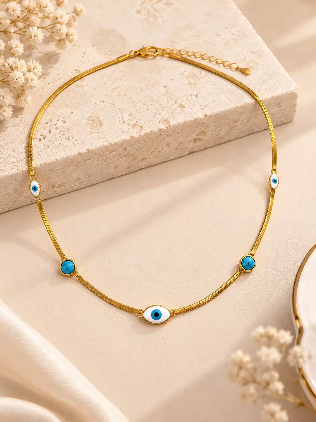 Gold-tone evil eye necklace for women with turquoise accents, three nazar motifs and adjustable chain by Orika Jewels