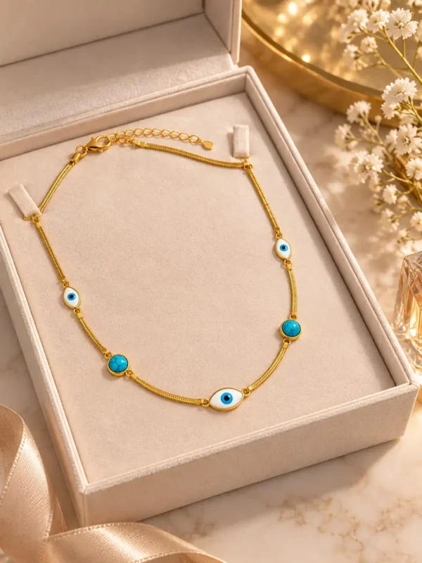 Gold-tone evil eye necklace with turquoise accents displayed inside an elegant jewellery gift box