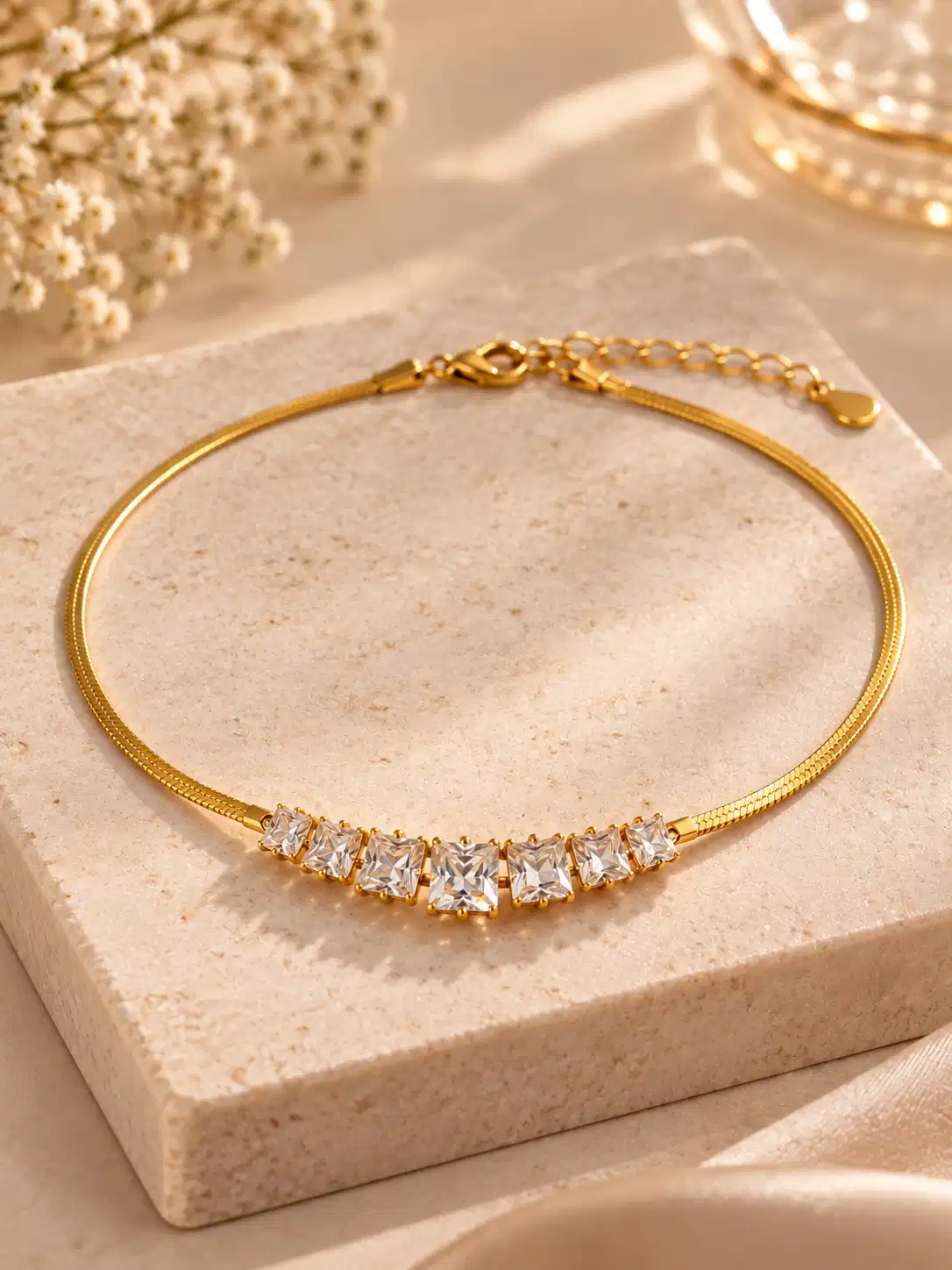 Gold-tone seven-stone crystal necklace with graduated square stones, lobster clasp and extension chain