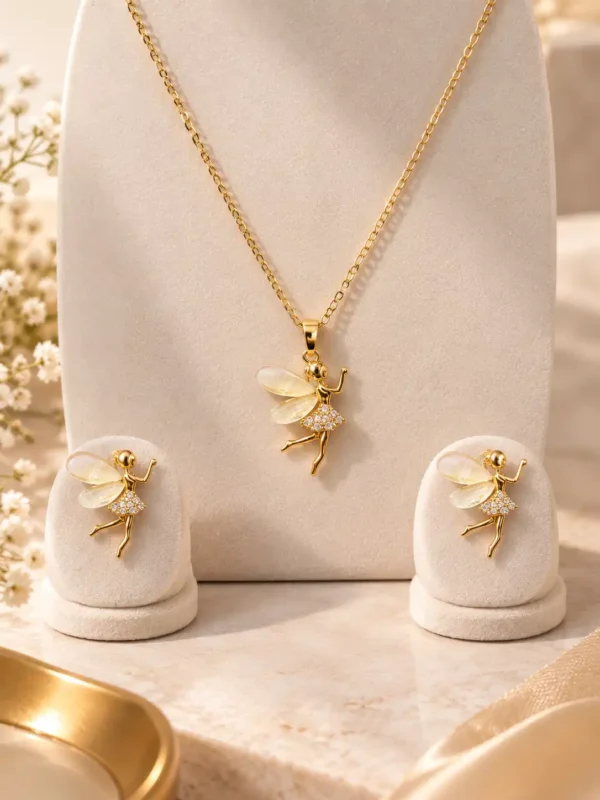 Aurelia gold tone fairy pendant necklace and matching earrings with translucent ivory wings and crystal-style detailing