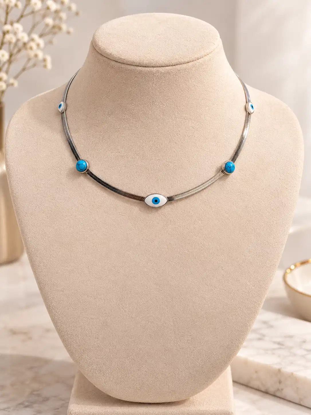 Silver evil eye necklace for women with turquoise blue accents and five nazar motifs
