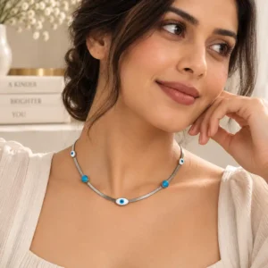 Woman wearing minimal silver nazar necklace with blue evil eye and turquoise details