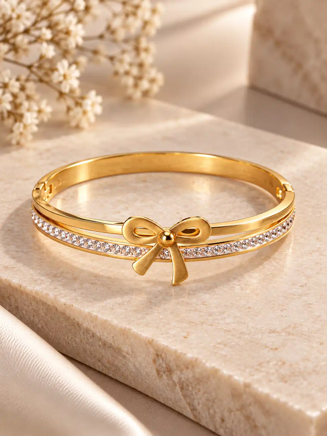 elara-crystal-bow-gold-tone-bangle