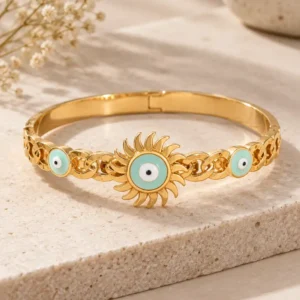 Gold-tone Solara Sunburst Evil Eye bangle for women with a large turquoise nazar centre and two smaller evil-eye motifs.