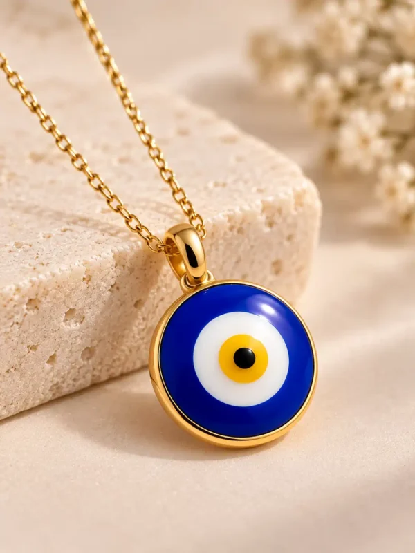 Close-up of cobalt blue evil eye pendant with white yellow and black nazar detail in polished gold-tone frame