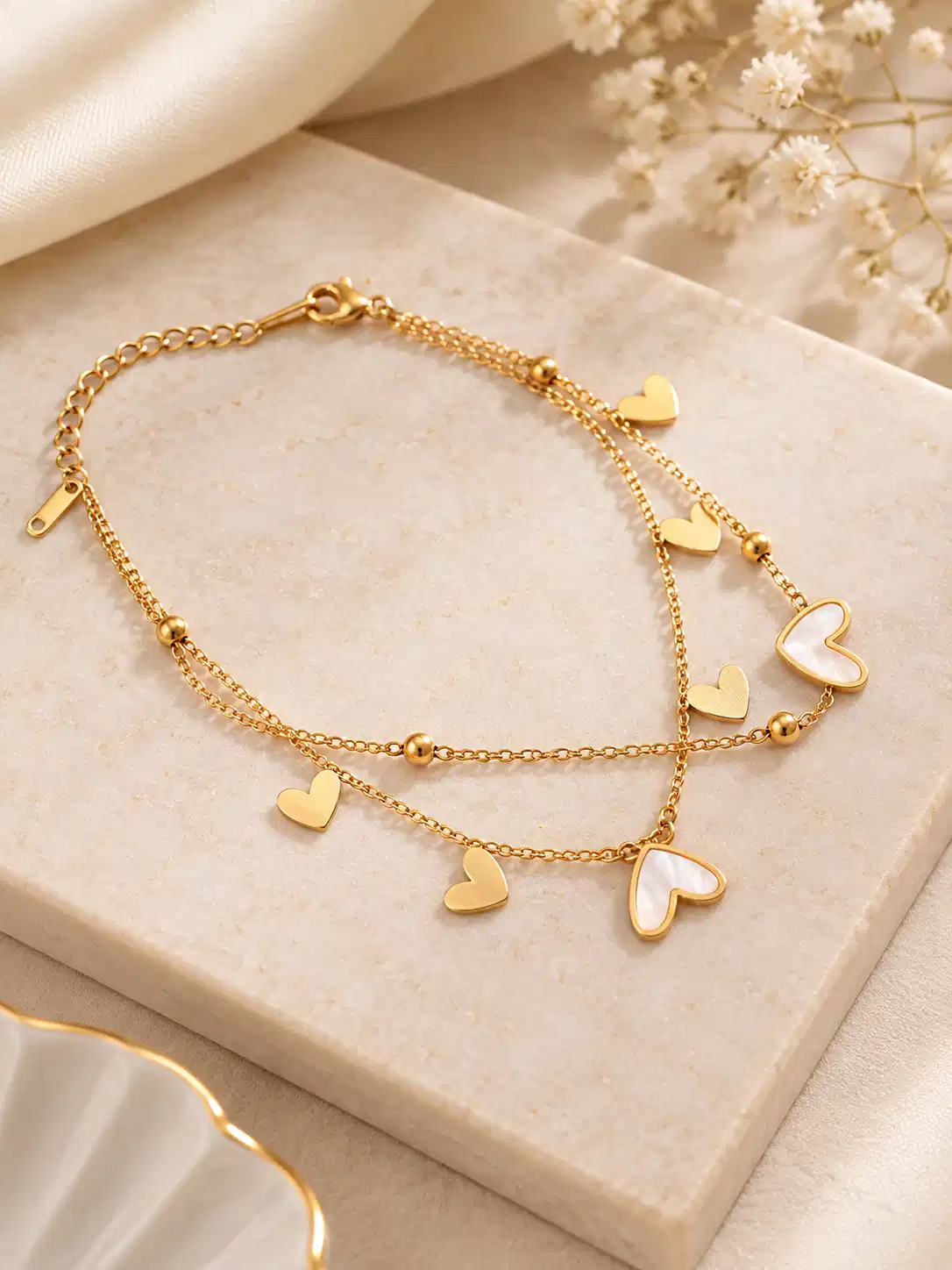 Amora gold layered heart charm bracelet with ivory heart accents for women