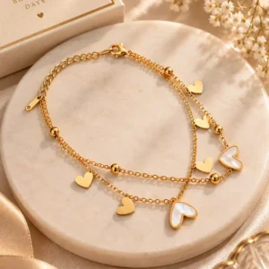 Gold double layer heart charm bracelet with ivory hearts styled as a gift for women