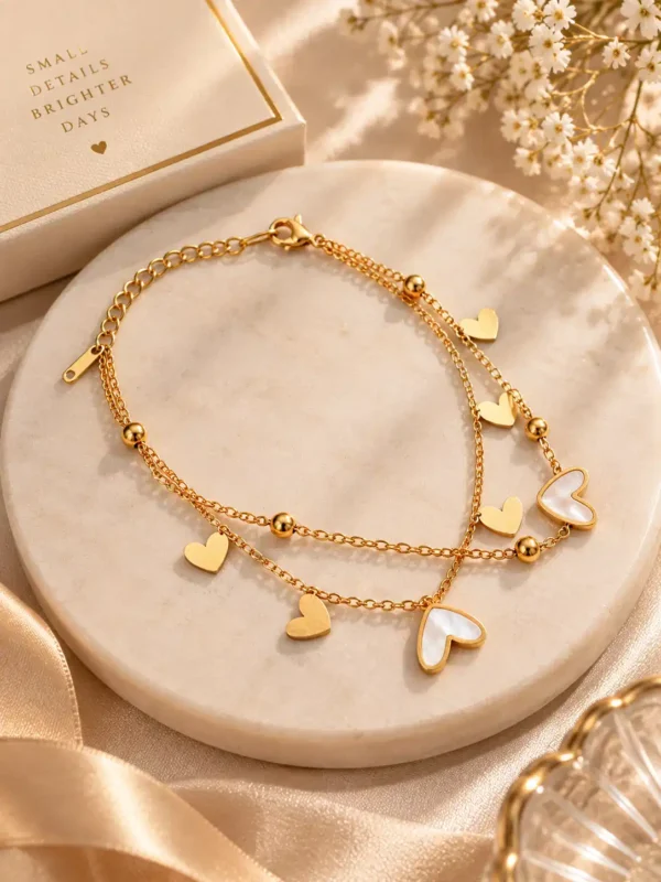 Gold double layer heart charm bracelet with ivory hearts styled as a gift for women